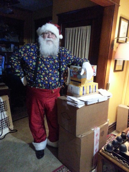 Bottom two boxes are the socks. The gift cards next, topped by Butterfingers and cocoa packets. Santa appears courtesy of me. For scale purposes only.