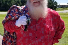 Friday's look: they asked me to come as Santa to hand out toys to the children. The ones who got flooded out with the storm surge had lost all their toys. Santa was a big hit with the little ones.