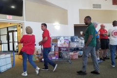 Always people in motion in the chapel, where our supplies are stockpiled.