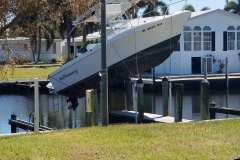 Boats do not belong on the dock pilings. This one got tossed up there during the hurricane. It looks like the hull is cracked but hopefully can be repaired.